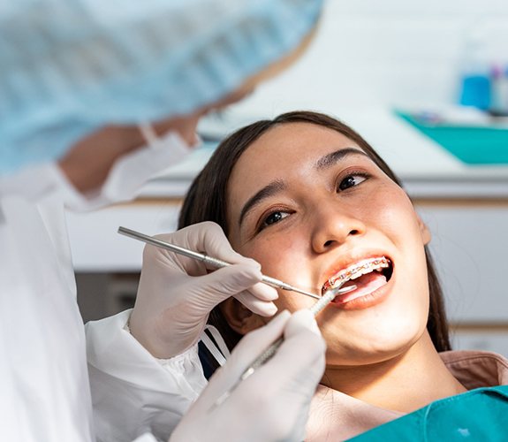 Woman having her teeth and braces checked regularly