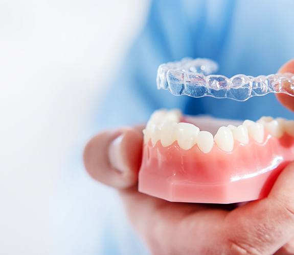Orthodontist showing patient clear aligners