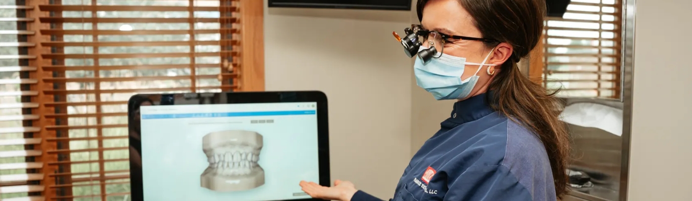 Picture of the team member with a mask showing a screen