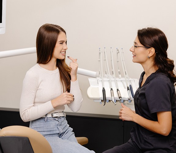 Female patient and dentist discussing cost
