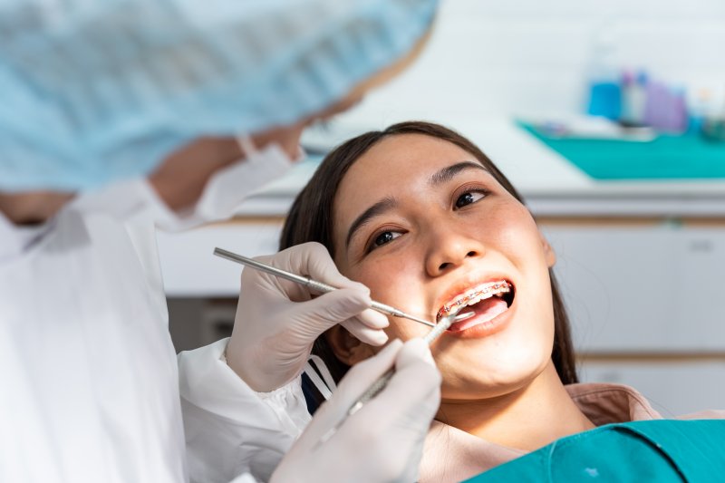 female patient wearing traditional braces