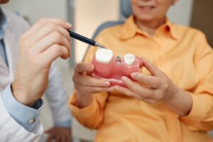 dentist showing a dental implant to a patient